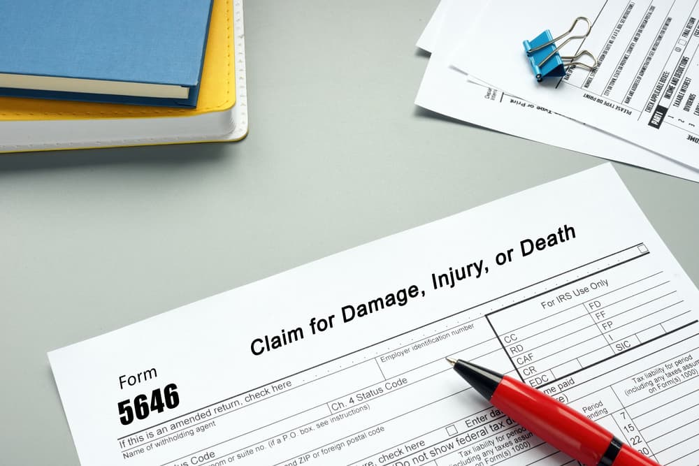 Close-up of a piece of paper with the phrase 'Form 5646 Claim for Damage, Injury, or Death,' representing a legal document for filing claims related to injury or wrongful death.