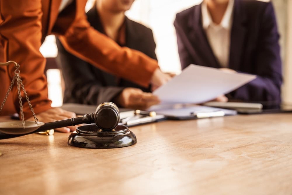 Image of a lawyer providing legal advice, representing clients in court, and assisting with legal documents, emphasizing their role in studying laws to protect clients' rights and interests.