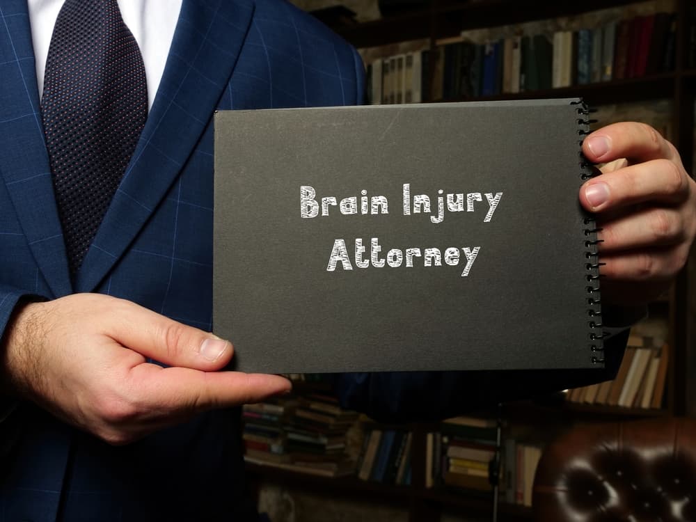 Brain Injury Attorney inscription written on a sheet of paper, showcasing legal services related to brain injury cases.