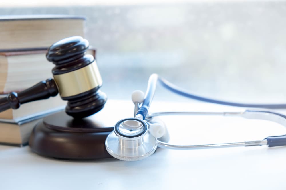 Gavel and stethoscope symbolizing medical jurisprudence, with a focus on legal definitions of medical malpractice, highlighting common errors made by doctors, nurses, and hospitals.